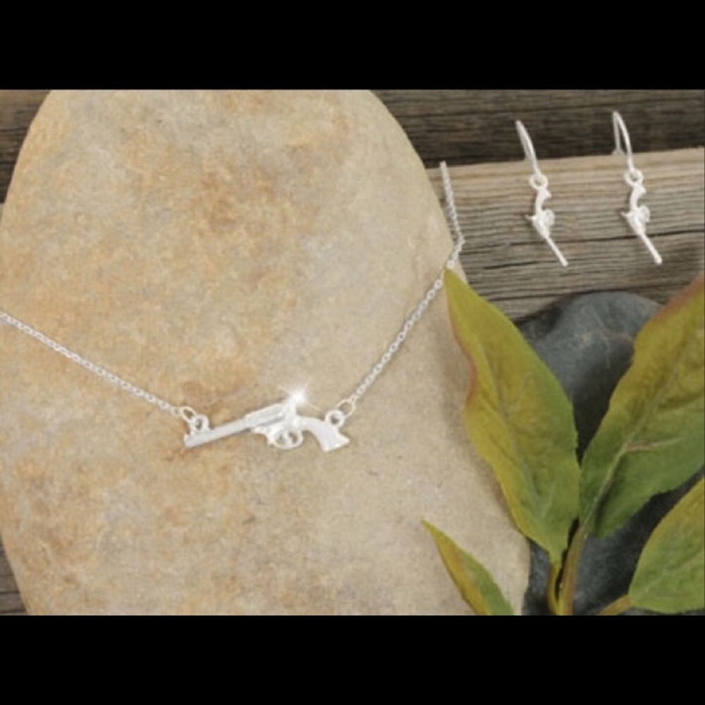 White enameled handled pistol designer necklace.